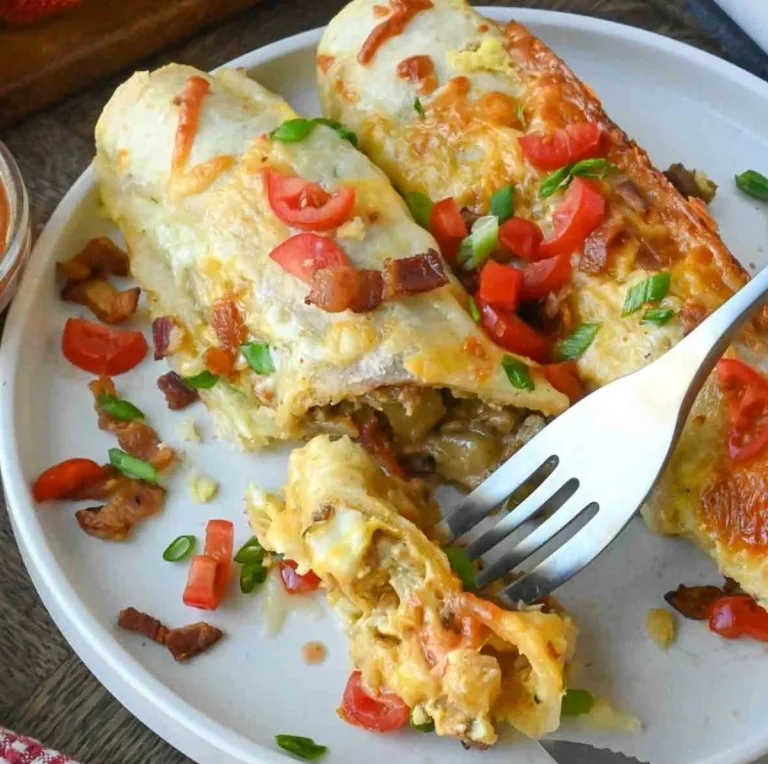A plate of delicious breakfast enchiladas topped with cheese and fresh herbs