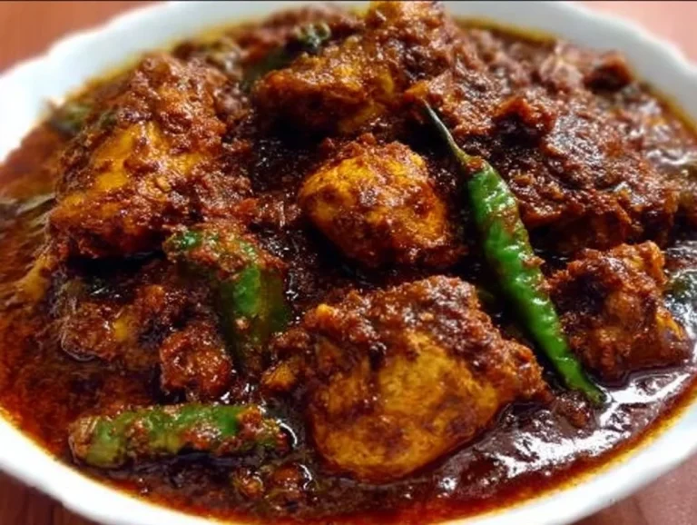 A vibrant dish of Chicken Bhuna Masala garnished with fresh herbs and spices.