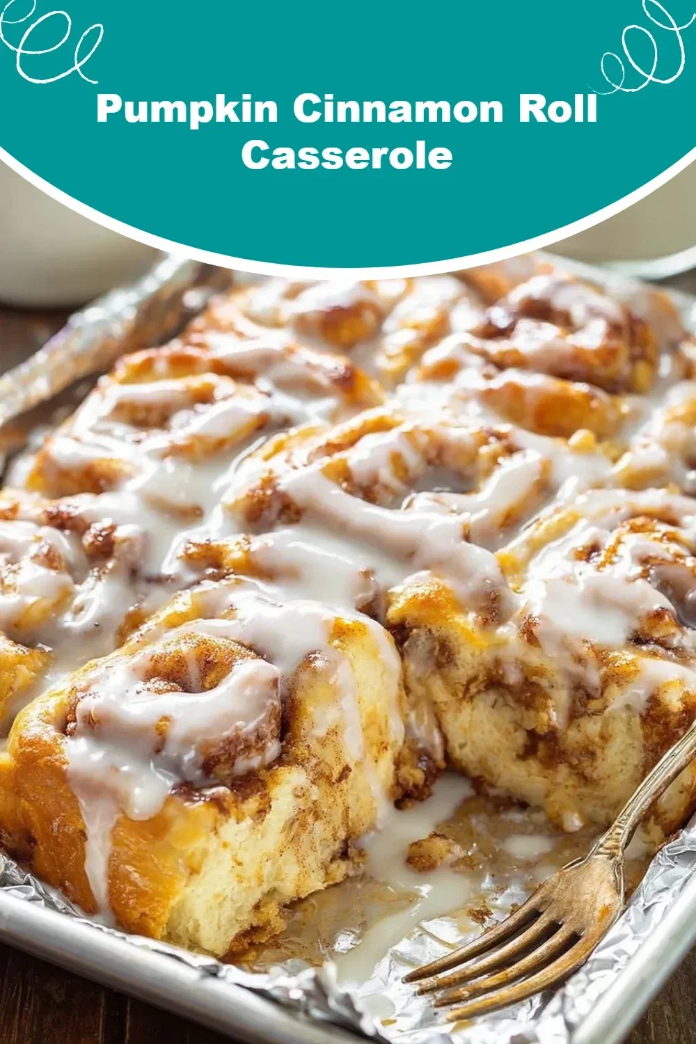 A delicious Pumpkin Cinnamon Roll Casserole topped with cream cheese icing.