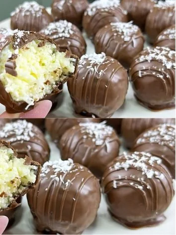 Delicious coconut chocolate truffles topped with coconut flakes and cocoa powder.