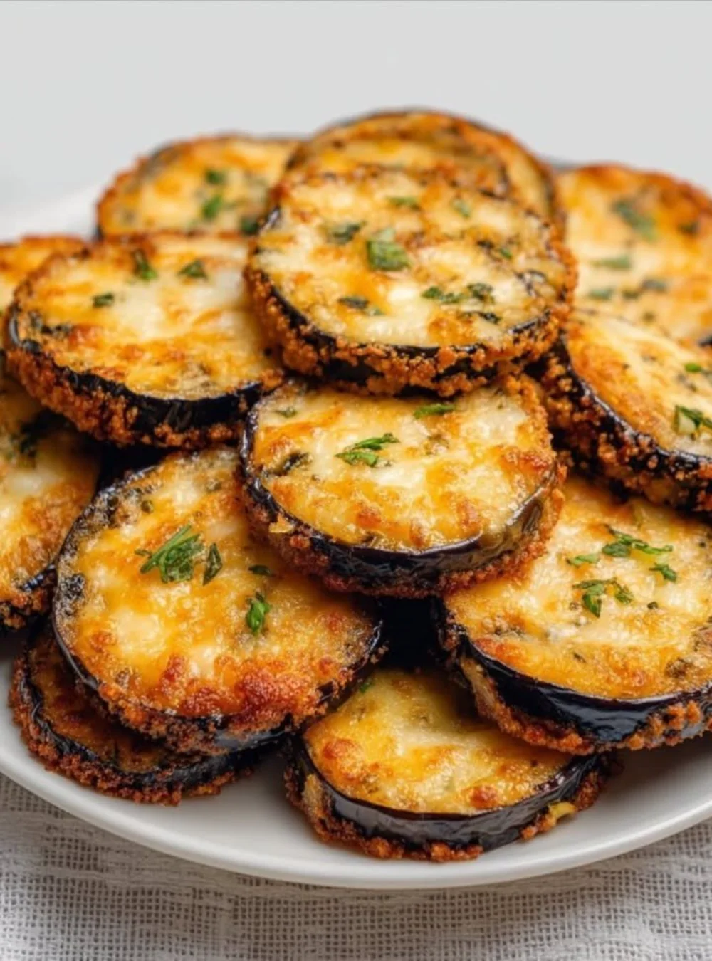 Golden roasted eggplant garnished with herbs, a delicious side dish.