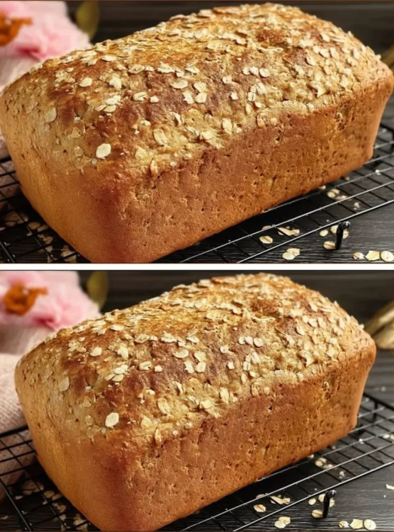 Loaf of fresh no sugar bread on a cutting board with herbs and seeds.