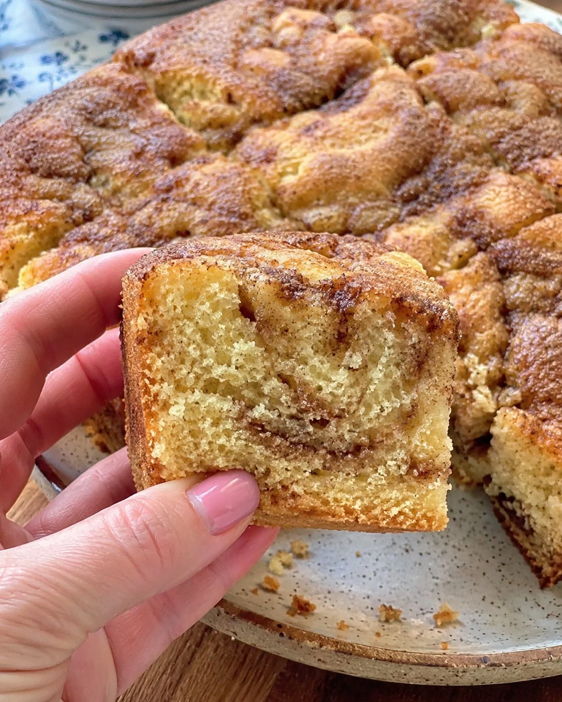 Amish-style cinnamon sour cream cake decorated with cinnamon sugar on top.