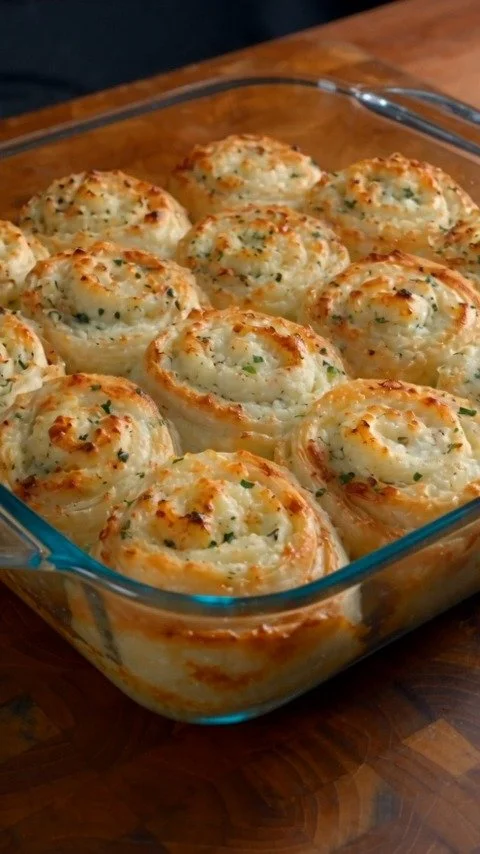 Creamy Garlic Parmesan Potato Bake topped with cheese and herbs